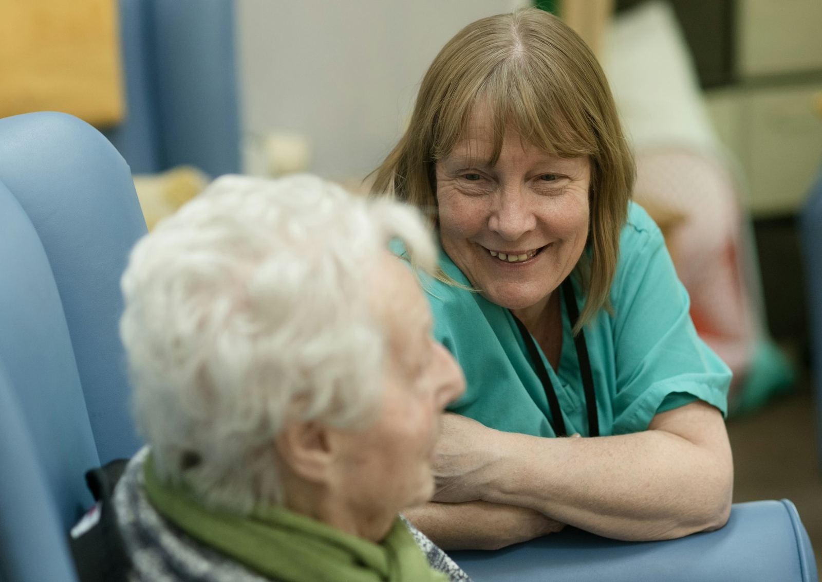 A caregiver smiling with an older resident