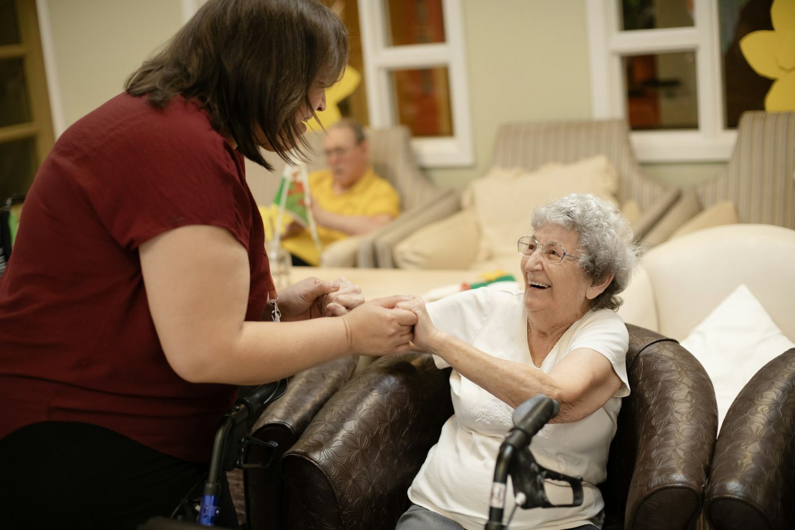 A caregiver holding a resident's hands