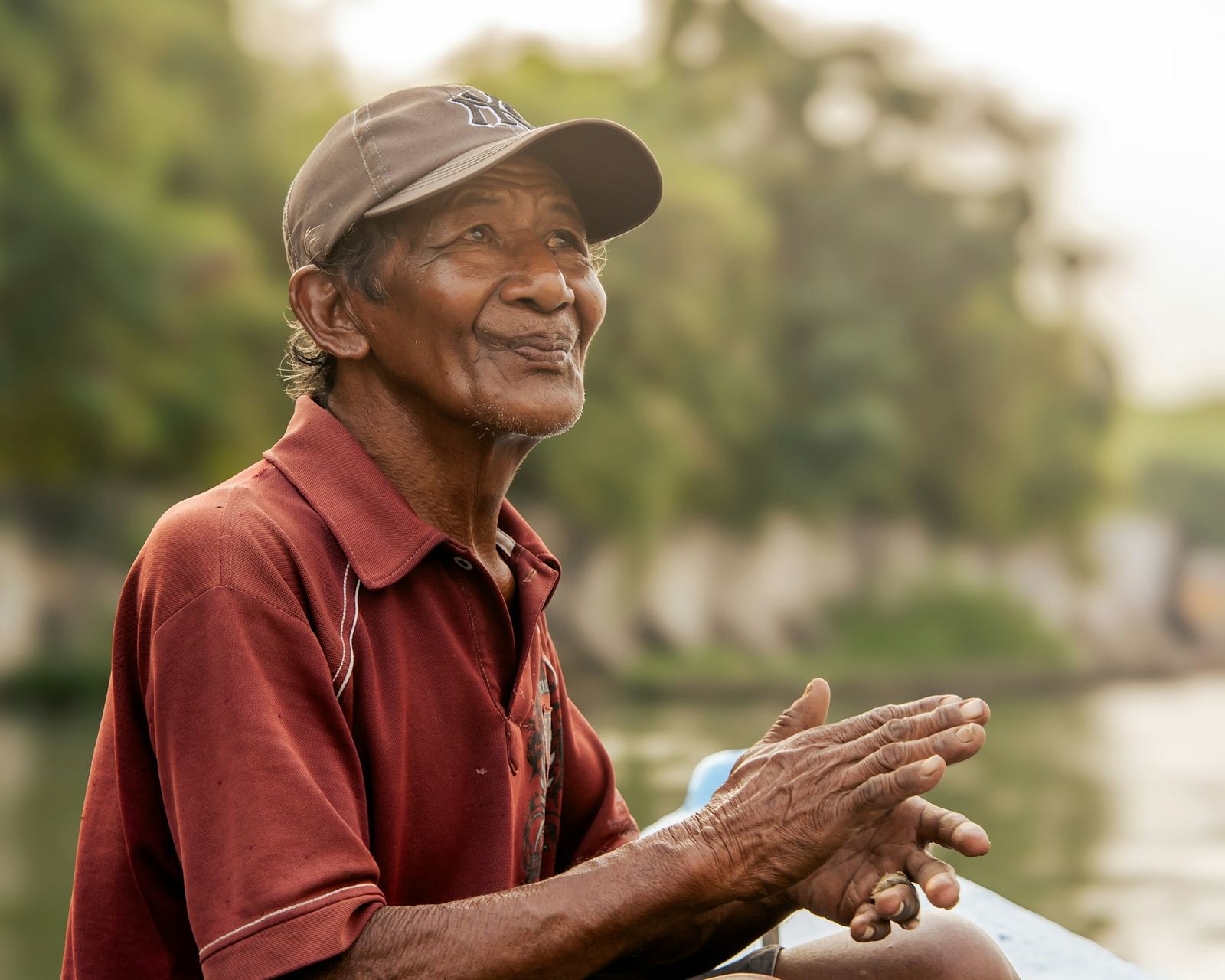 An older man smiling outdoors